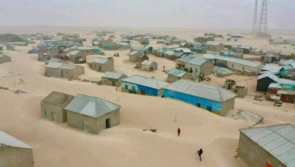 Houses in Dhinowda half covered by a moving dune